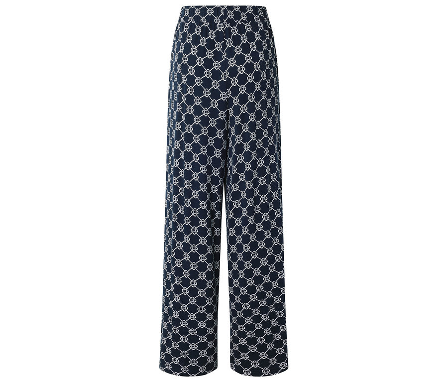 Un pantalon long bleu marine avec un motif blanc répétitif.