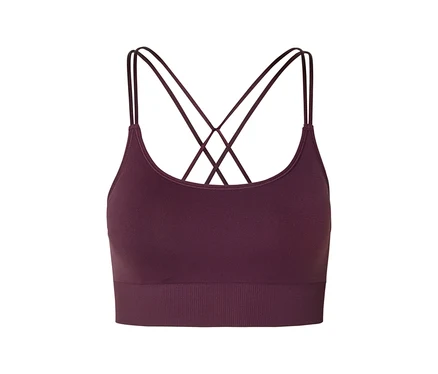 Gros plan d'une brassière de sport bordeaux avec des bretelles croisées sur fond blanc.