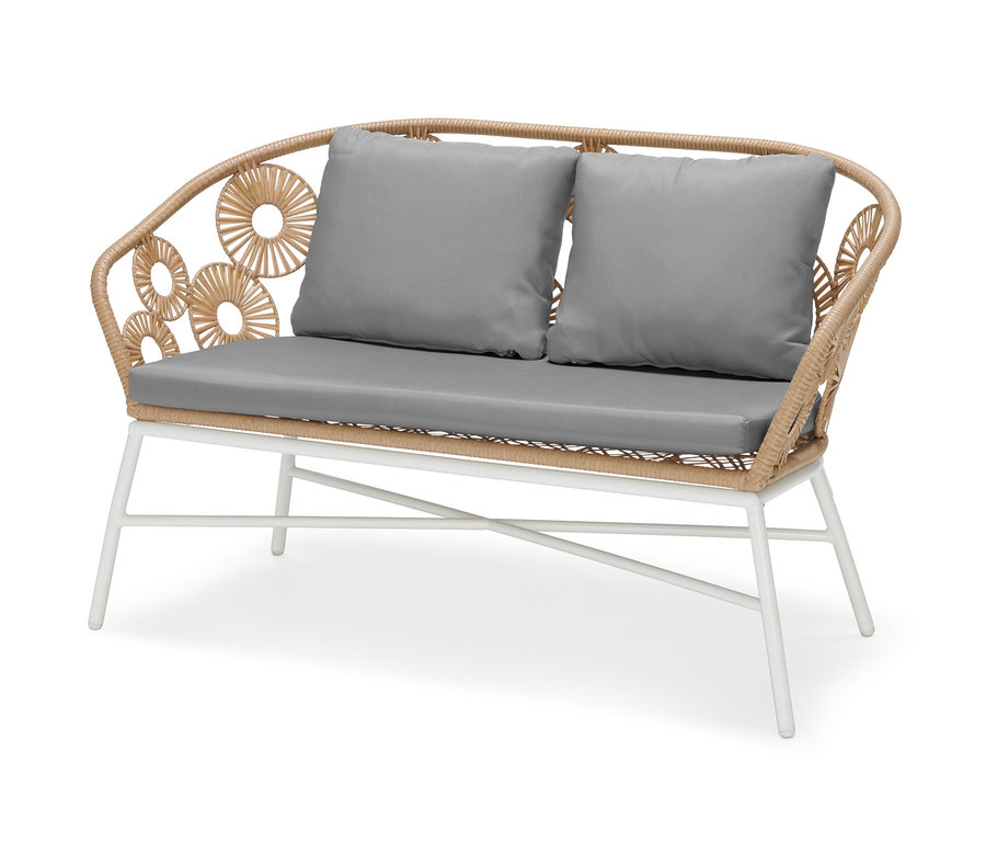 Banc à motif floral avec deux coussins gris.