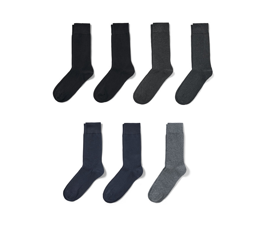 Sept paires de chaussettes en noir, gris foncé, bleu et gris clair.