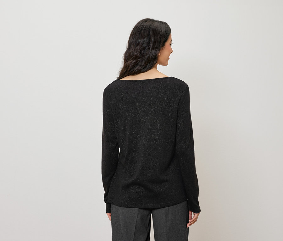 Vue de dos d'une femme aux cheveux foncés portant un haut noir à manches longues scintillant.