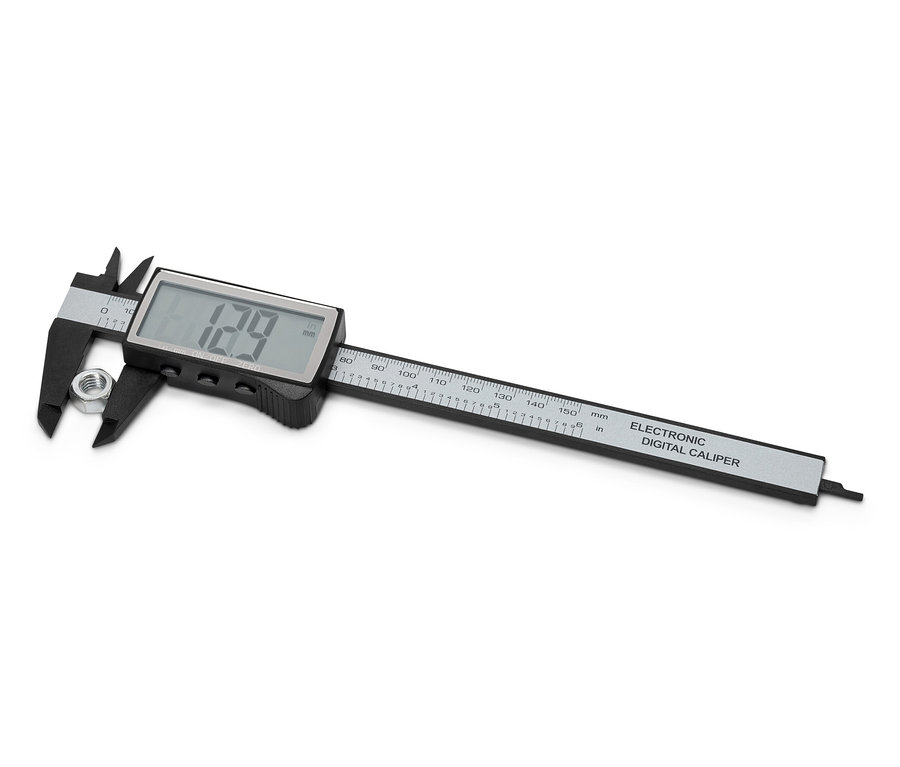 Un pied à coulisse numérique mesure un écrou.