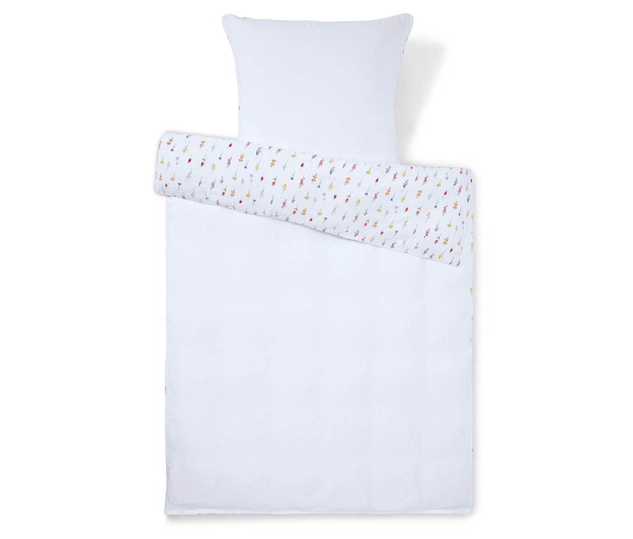 Ensemble de literie comprenant une taie d'oreiller blanche et une couette blanche avec une enveloppe à fleurs colorées.