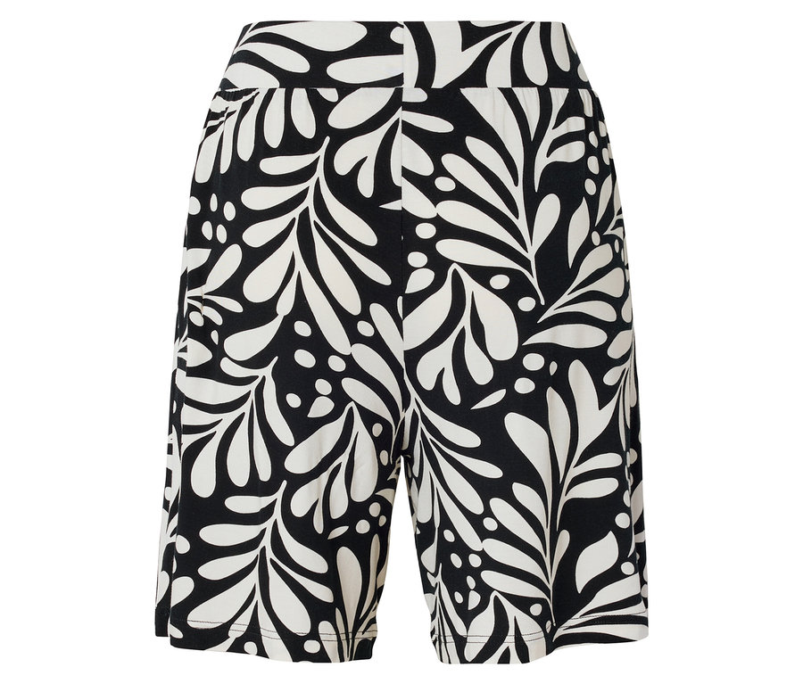 Shorts avec fond noir et motif de feuilles blanches.