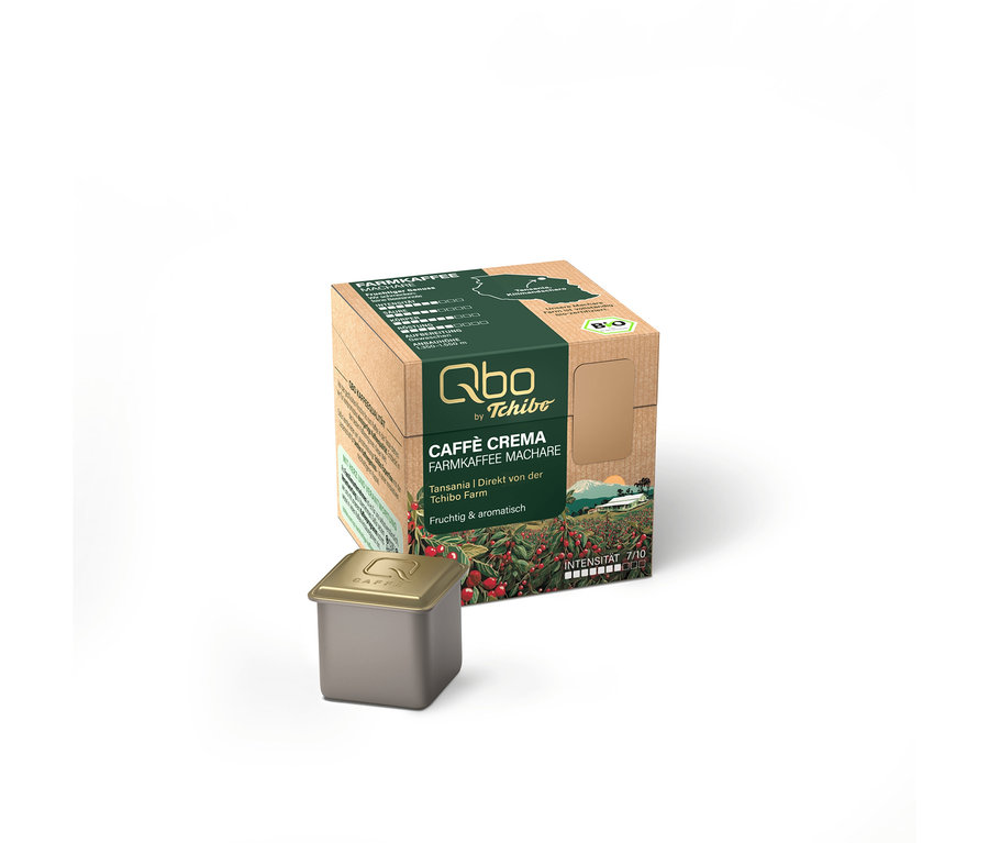 Une boîte de capsules Qbo Caffè Crema Café de Plantation Machare marron avec des accents verts et une capsule gris foncé devant.