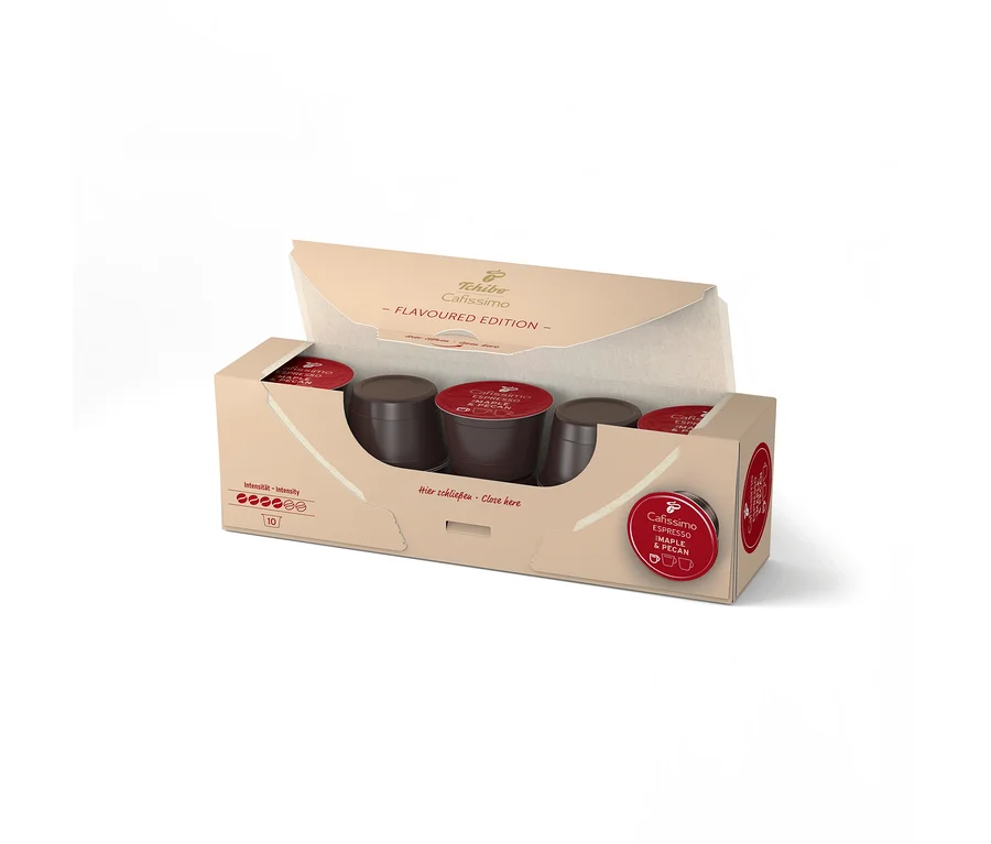 Boîte ouverte de 10 capsules Tchibo Cafissimo Espresso saveur Érable & Noix de Pécan, montrant des capsules marron foncé à couvercles rouges.