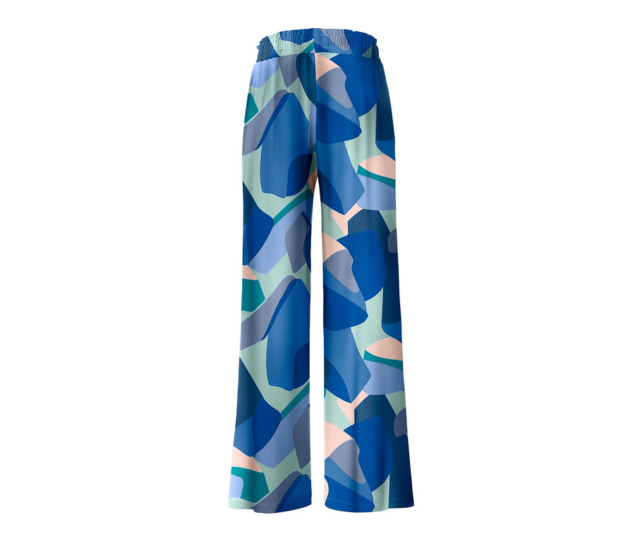 Un pantalon relax avec un motif géométrique bleu et vert.