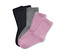 Quatre paires de chaussettes pour enfant : deux noires, une grise et une violet pastel.