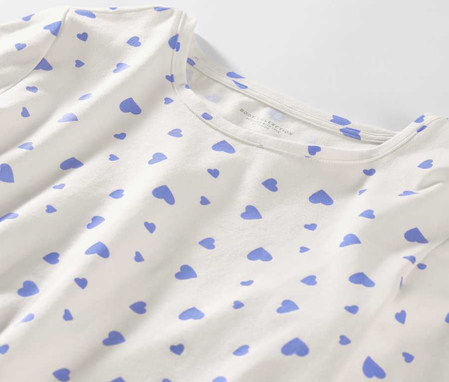Gros plan sur un pyjama blanc avec des cœurs bleu clair.