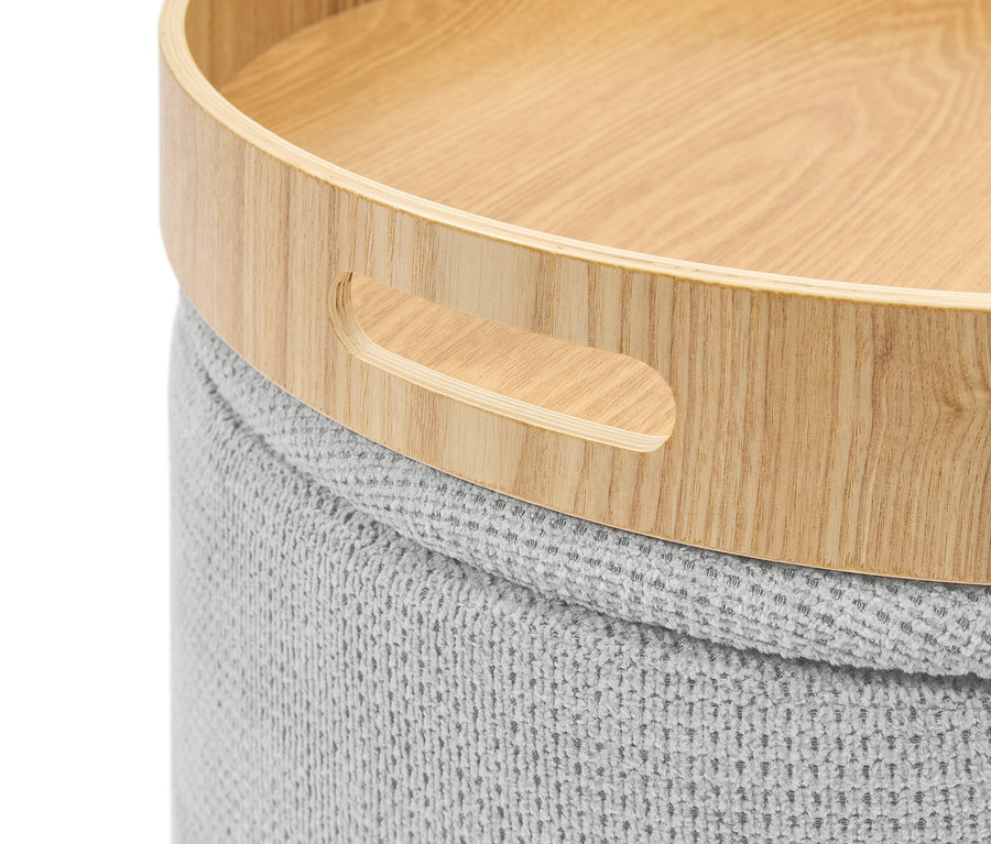 Gros plan d'un pouf gris tricoté avec un plateau en bois muni de poignées.
