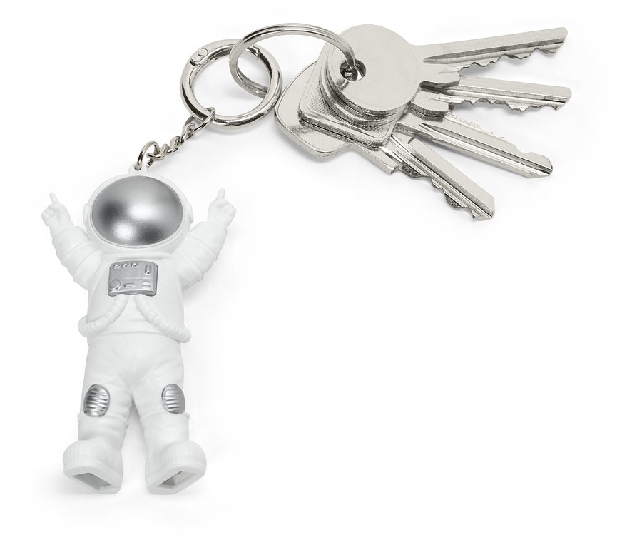 Porte-clés avec une petite figurine d'astronaute en combinaison blanche et casque argenté, attaché à un trousseau de clés argentées.