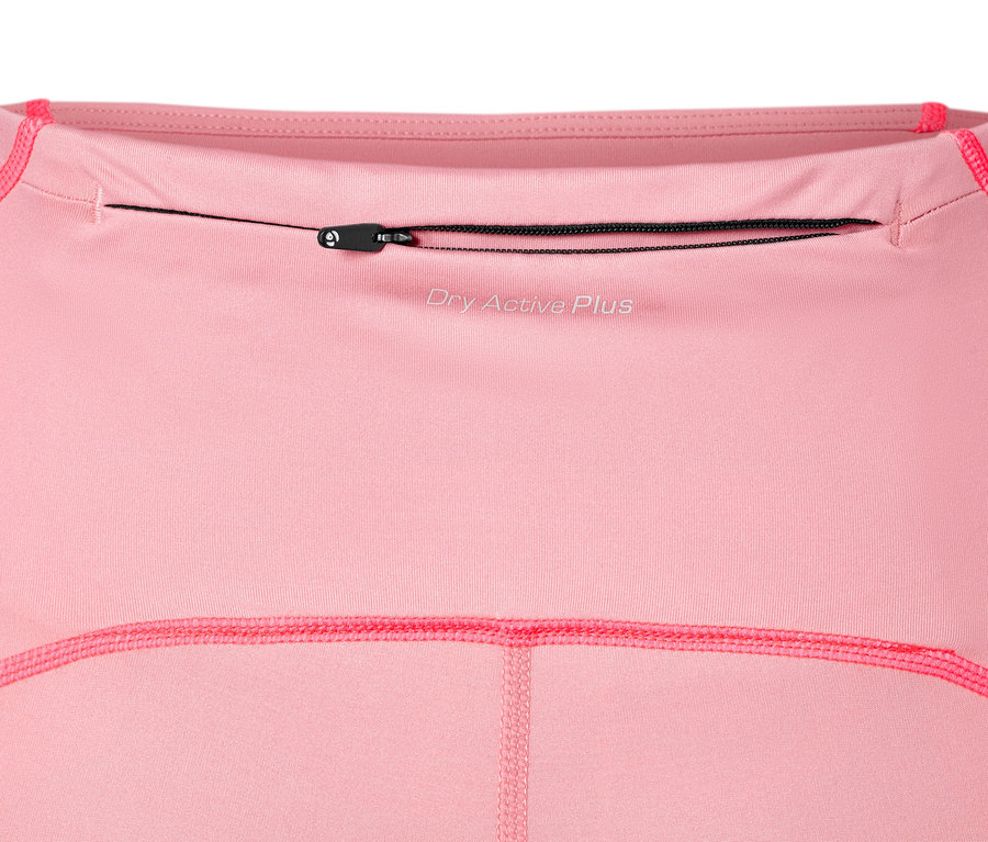 Vue détaillée d'un legging de sport Performance rose avec une poche zippée.