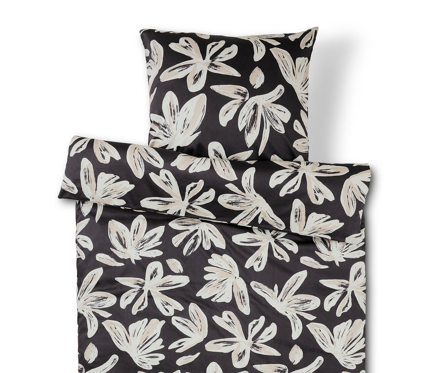 Linge de lit noir et blanc avec motif floral.