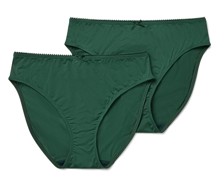 Deux culottes vertes de coupe classique avec un nœud papillon sont posées sur un fond blanc.