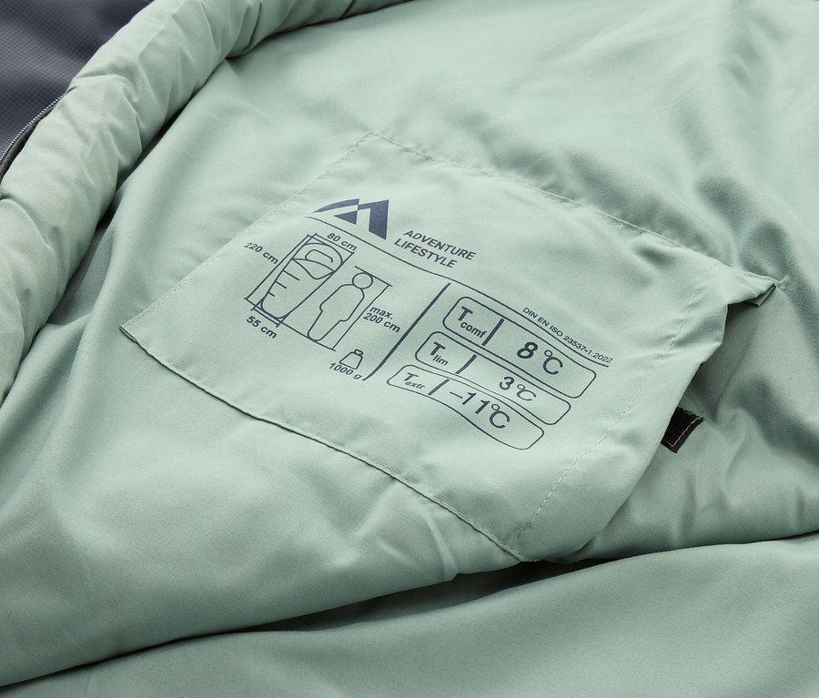 Gros plan d'un sac de couchage vert clair avec les spécifications de température et les informations de taille.