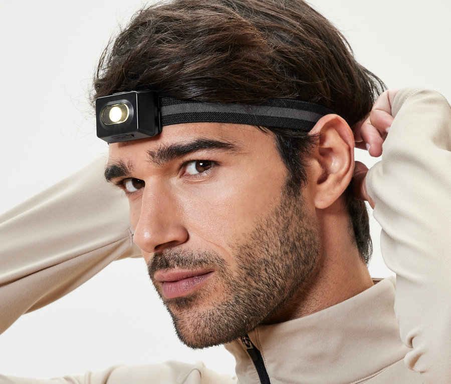 Un homme ajuste sa lampe frontale.