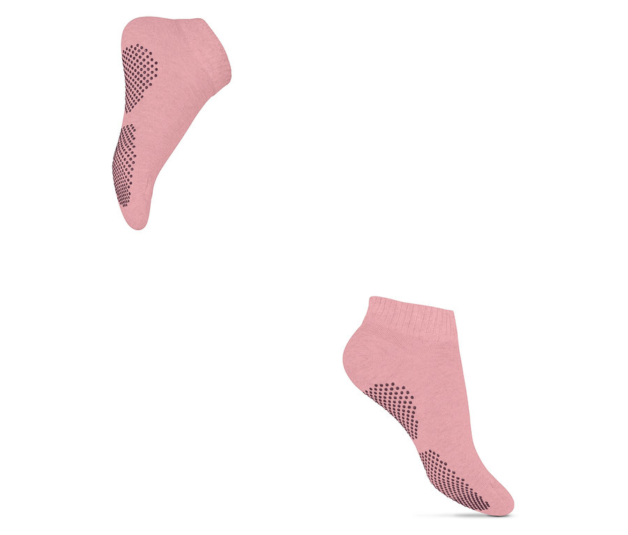 Deux paires de chaussettes de yoga roses avec semelle antidérapante.