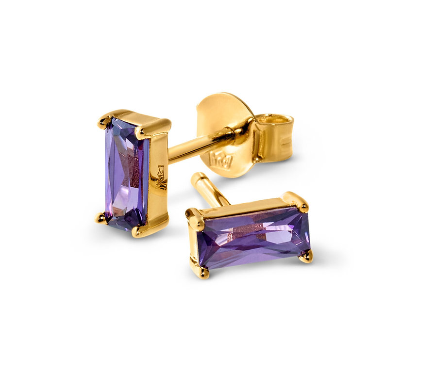 Gros plan de trois clous d’oreilles en or avec des pierres violettes.