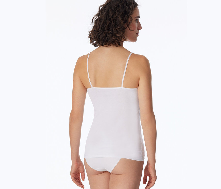 Vue arrière d'une femme aux cheveux bruns et bouclés portant un top SCHIESSER blanc et une culotte blanche.