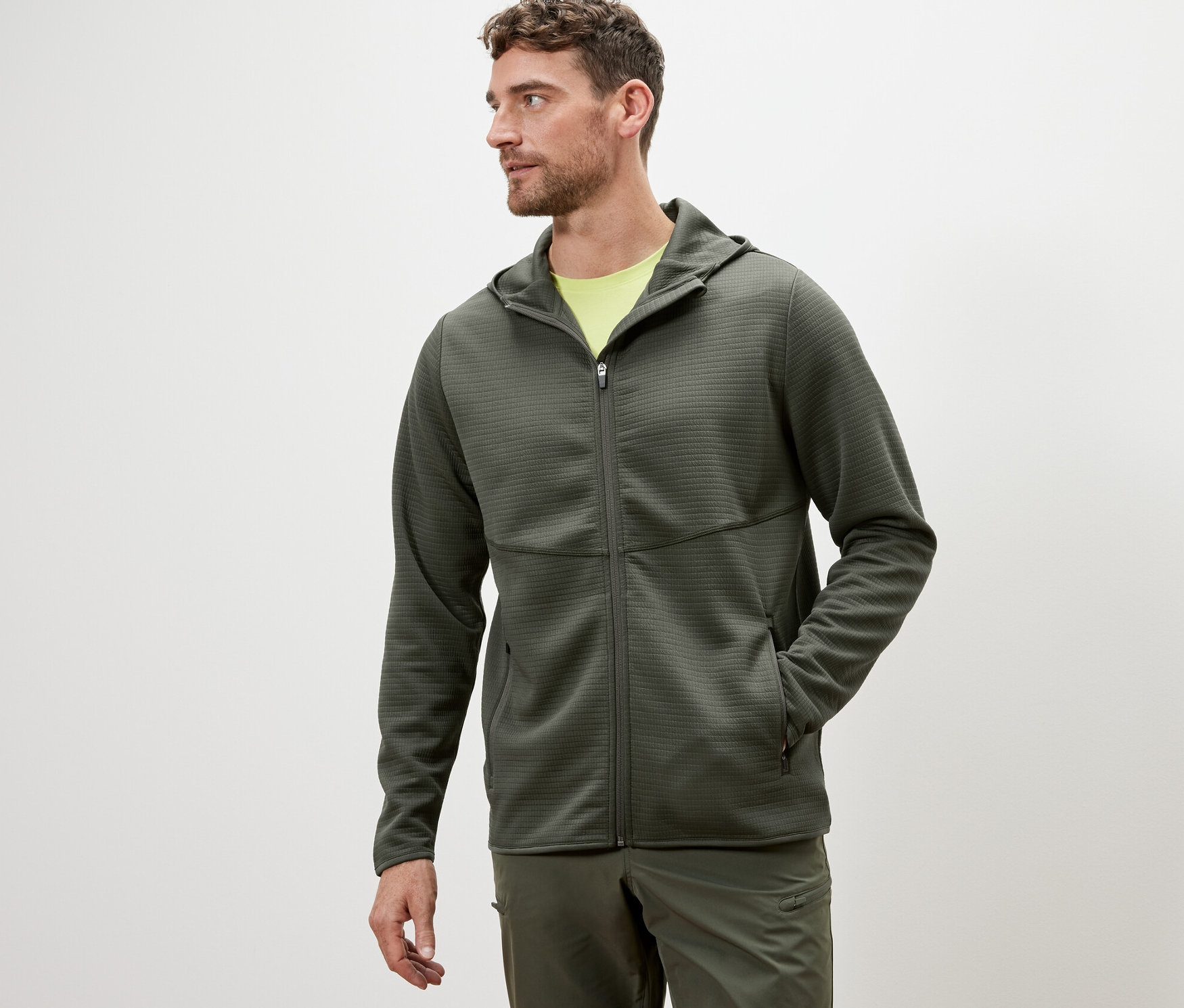 Un homme portant une veste fonctionnelle kaki.