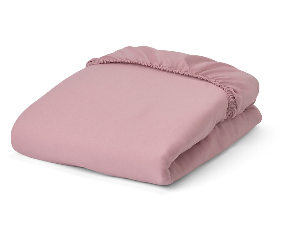Drap-housse rose en microfibre plié.