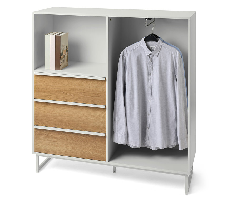 Commode «
LEEG
» avec 3 tiroirs et tringle à vêtements, ainsi que des livres et une chemise sur la photo.