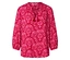 Chemisier rouge à motif floral rose avec des pompons à l'encolure.