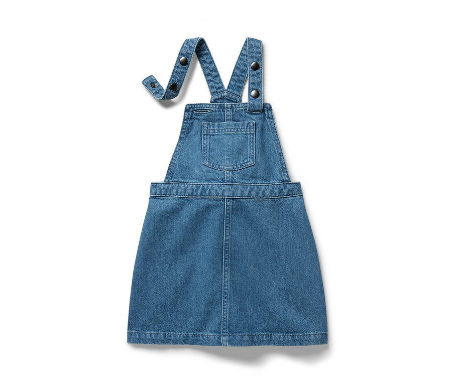 Une robe-salopette bleue en jean est sur un fond blanc.