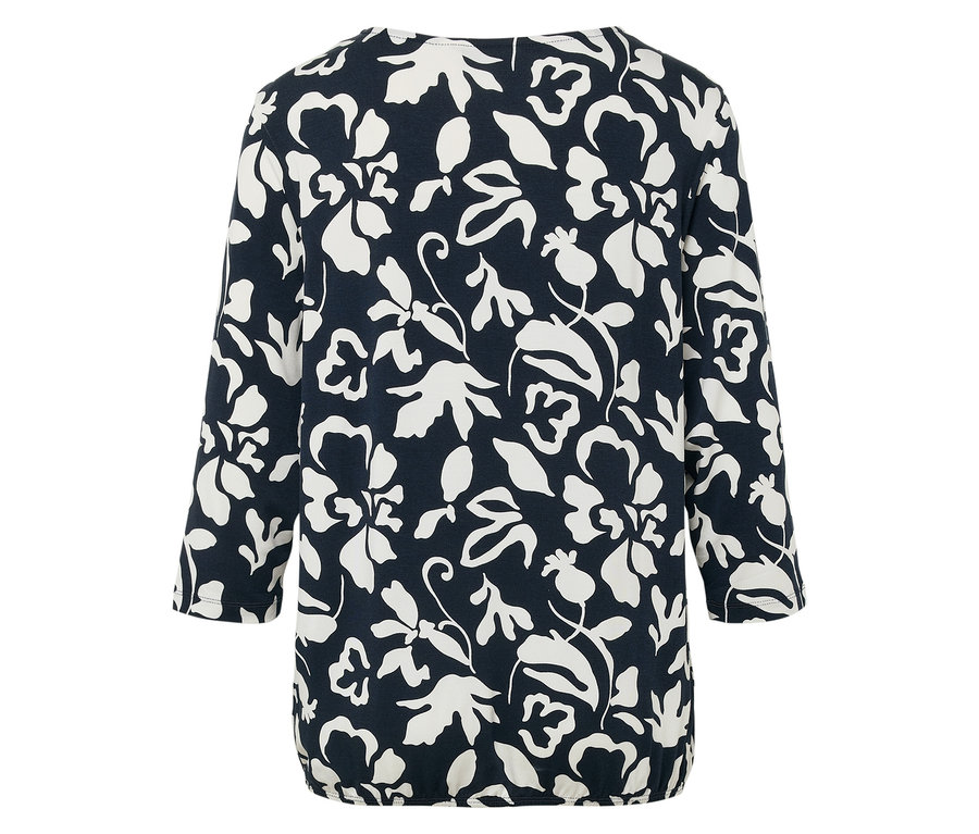 Blouse marine à fleurs blanches avec manches trois-quarts et ourlet élastique.