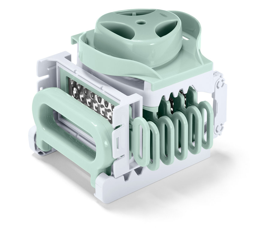 Gros plan sur un coupe-légumes de cuisine vert pastel et blanc.