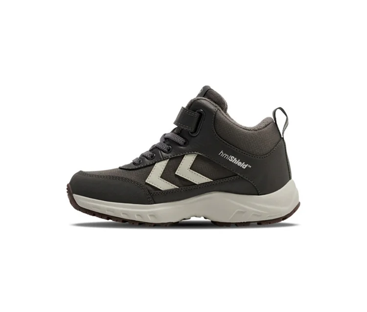 Baskets hummel® « Root Tex Jr » gris foncé avec des chevrons beige clair, une fermeture velcro et des lacets.