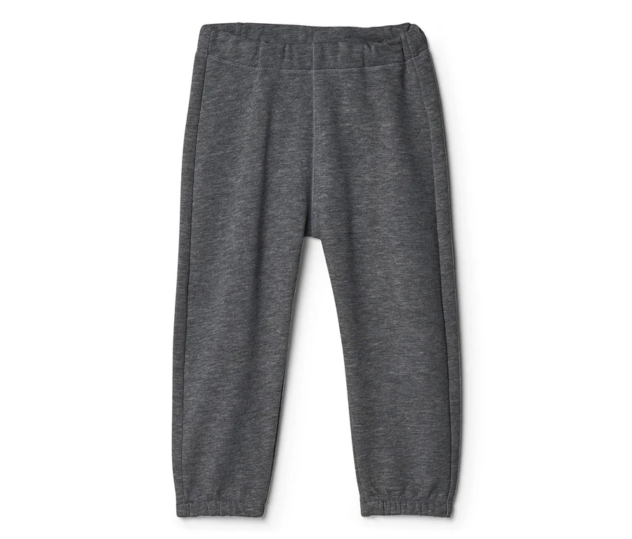 Pantalon en tissu-éponge gris foncé pour bébé avec taille et chevilles élastiques, posé à plat.