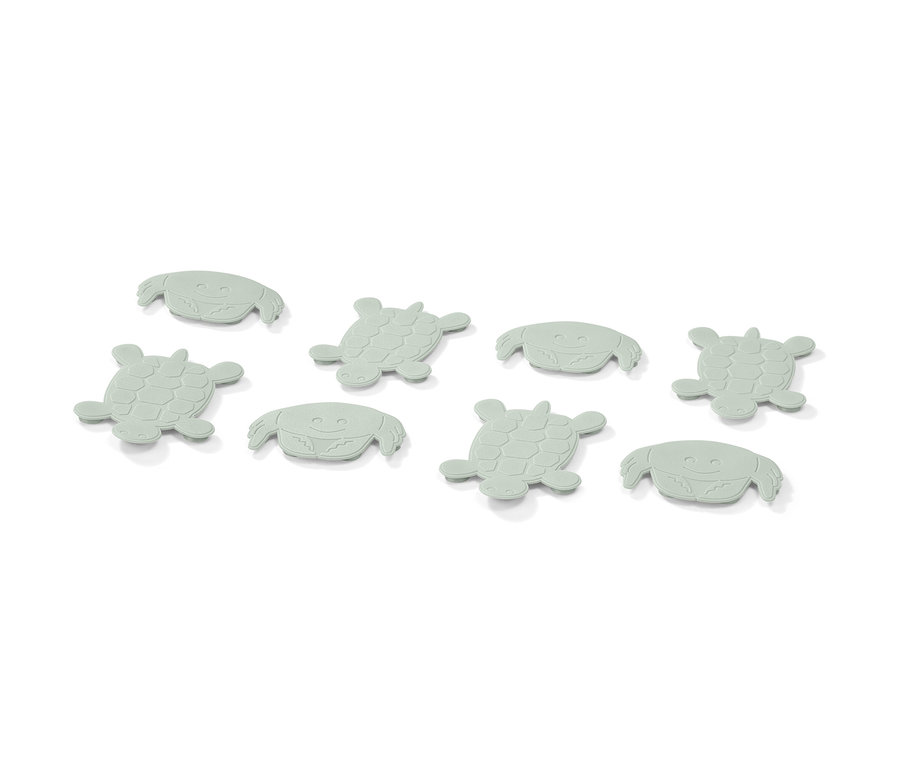 Huit pads anti-glisse vert clair en forme de crabes et de tortues.