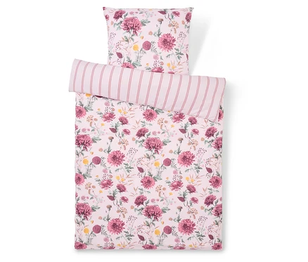 Linge de lit à motif floral avec oreiller rayé.