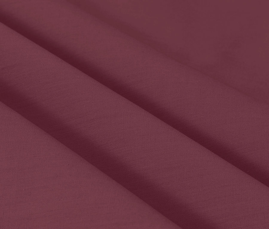 Gros plan sur une texture de tissu bordeaux avec des plis doux.