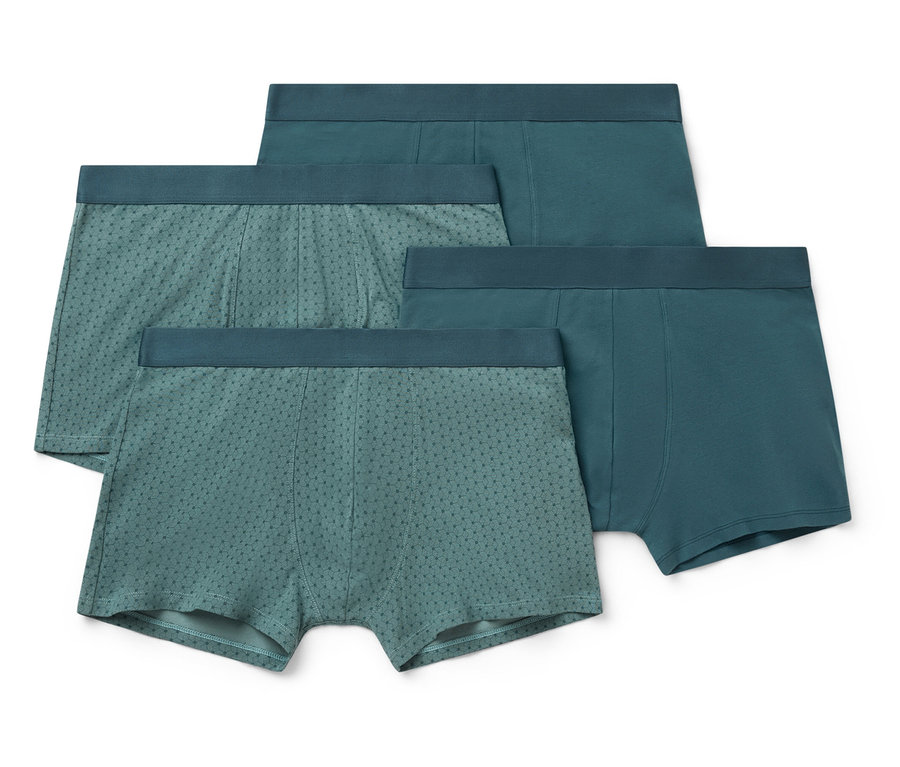 Quatre paires de boxers pour hommes dans différentes nuances de bleu-vert, certaines avec un motif à pois.