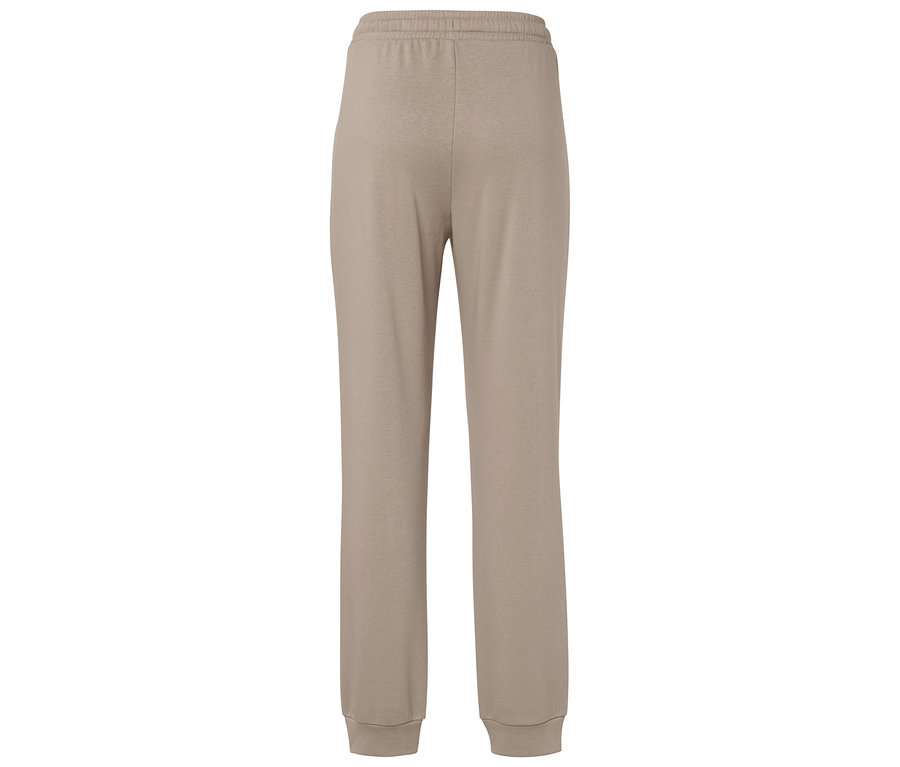 Pantalon de survêtement beige avec taille élastique et poignets.