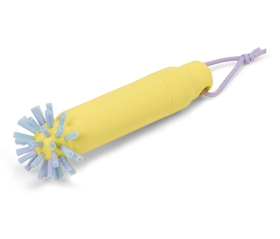 Brosse à biberon jaune avec des poils bleus et une boucle violette.