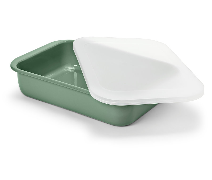 Un récipient vert avec un couvercle blanc repose sur un fond blanc.