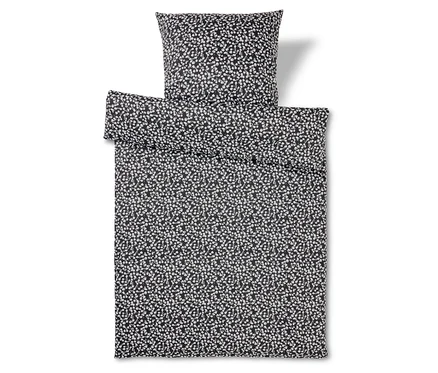 Ensemble de literie noir et blanc à motif à pois.