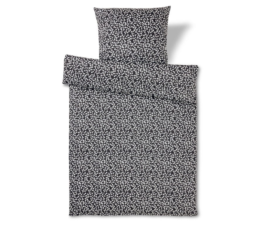Ensemble de literie noir et blanc à motif à pois.