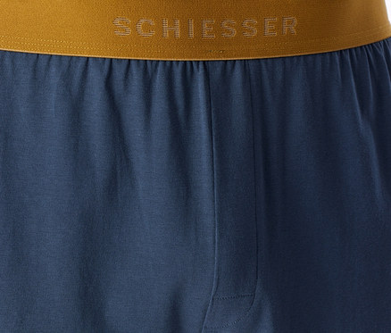 Bas de pyjama bleu avec une ceinture marron-doré sur laquelle est inscrit le logo « SCHIESSER ».