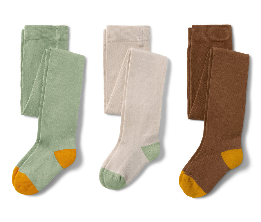 Trois paires de collants verts sont côte à côte.