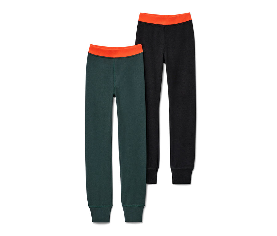 Deux caleçons thermiques d'hiver pour enfant : un vert foncé et un noir, tous deux avec une taille orange.