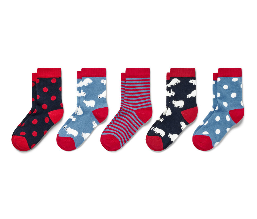 Cinq paires de chaussettes pour enfant avec différents motifs, dont des pois, des rayures et des ours polaires.