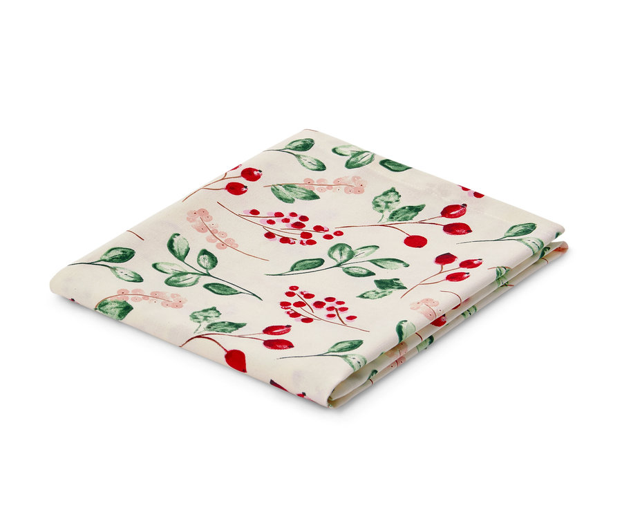 Nappe en coton pliée avec motif de baies rouges et de feuilles vertes.