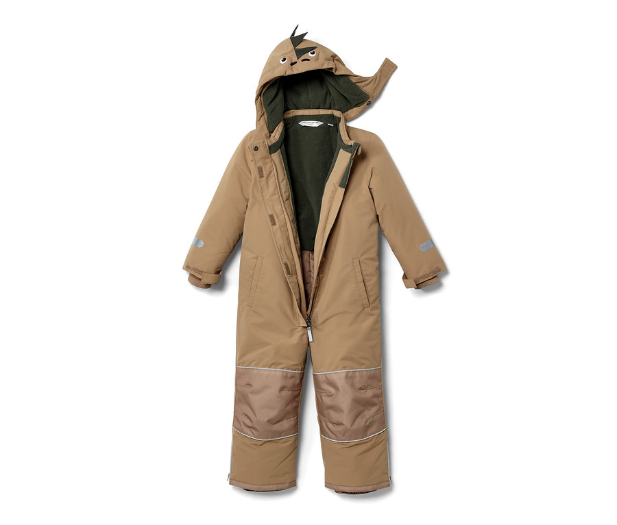 Une combinaison de neige beige pour enfant avec une capuche à motif de dinosaure, ouverte et posée sur un fond blanc.