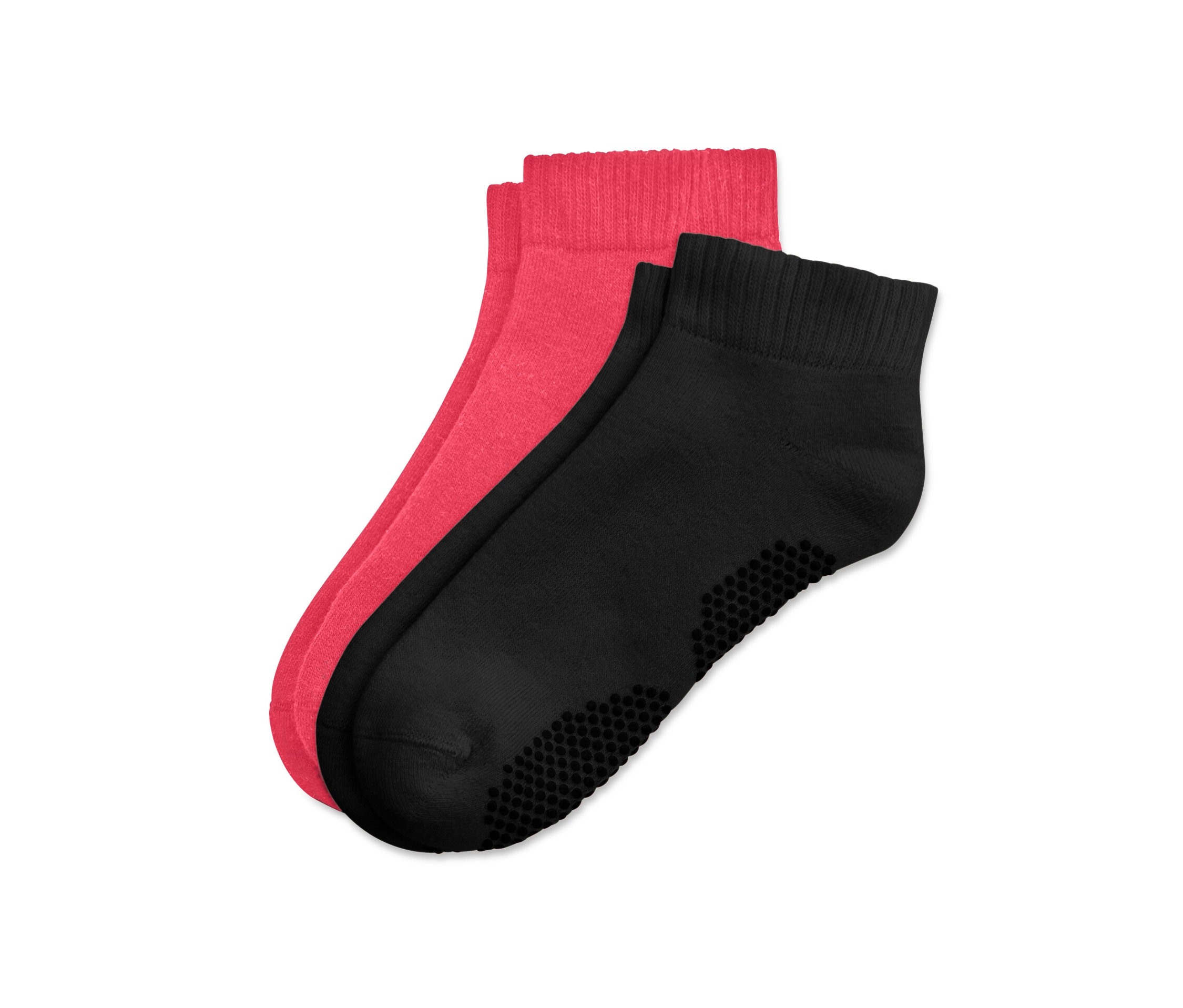 Deux paires de chaussettes de yoga, une paire noire et une paire rose vif, sont posées l'une sur l'autre.
