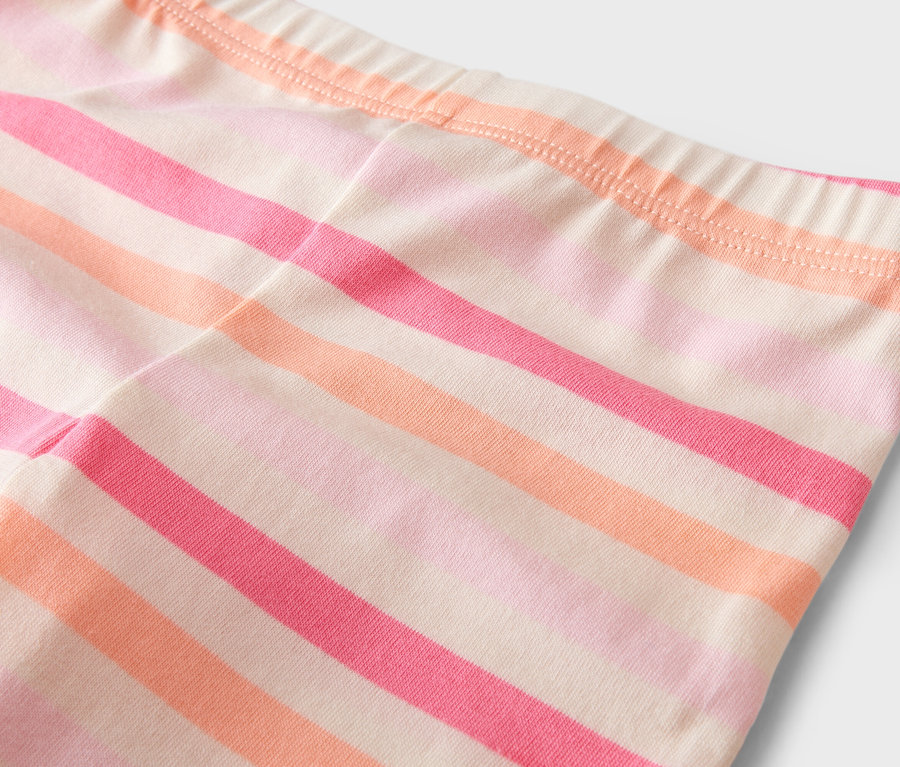 Gros plan sur un legging rayé dans les tons rose et orange.