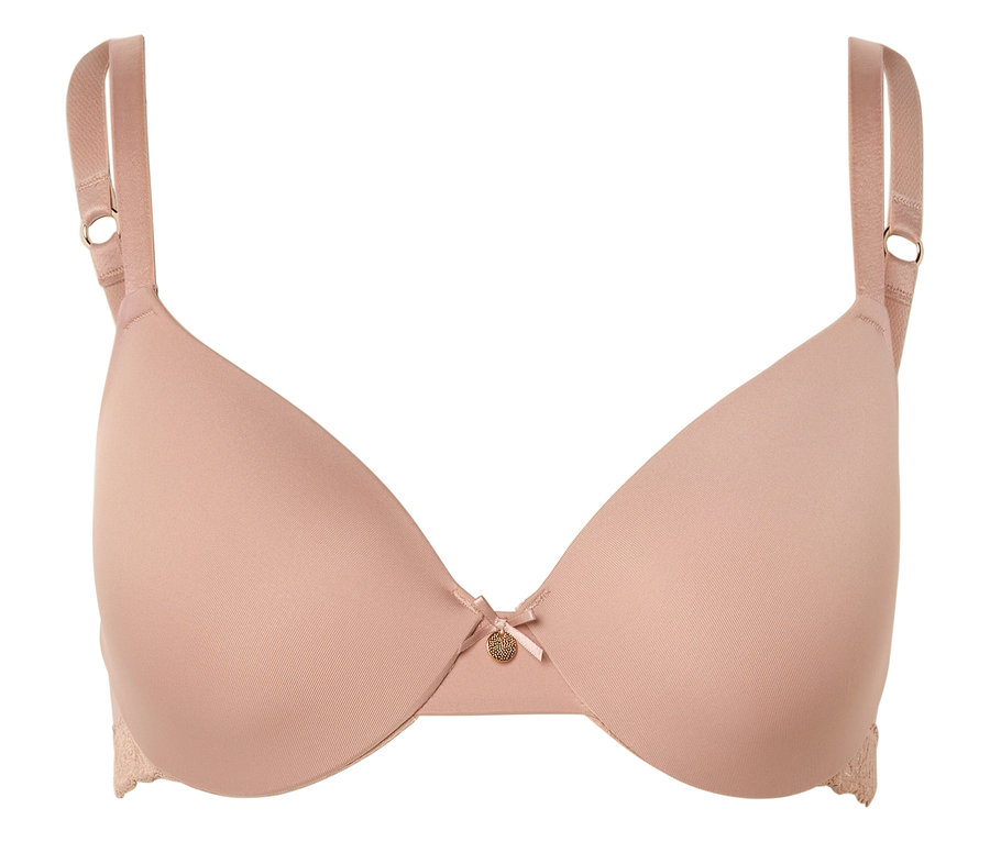 Un soutien-gorge couleur chair avec des bretelles réglables, un nœud et un petit pendentif doré au centre.